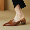 "Marloe Spitz zulaufende Leder-Mules" could be rewritten as "Marloe Elegante Leder-Mules mit spitz zulaufendem Design".