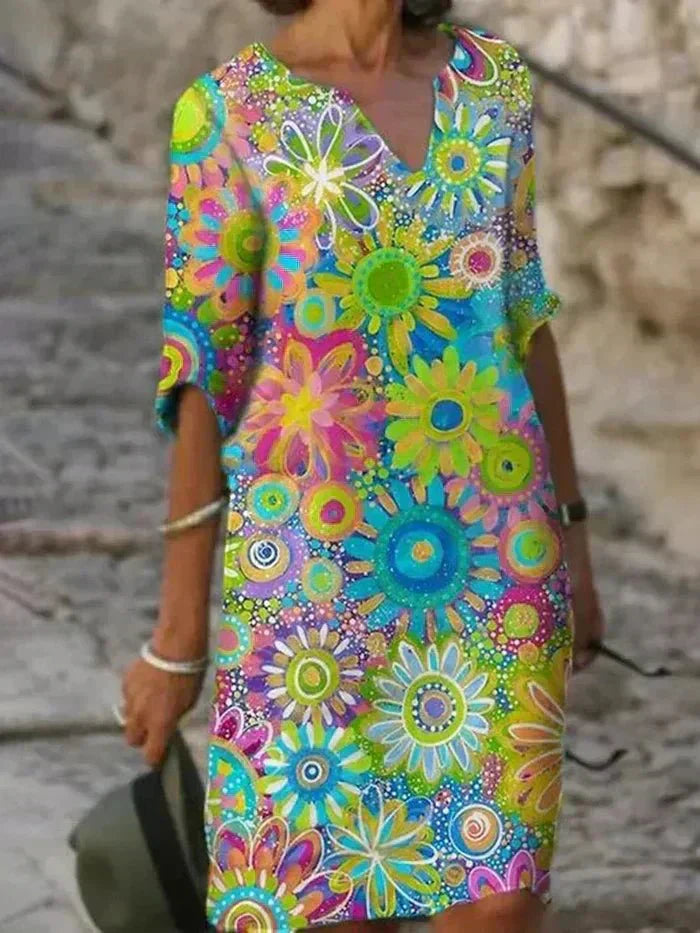 "Nira | Lebhaftes Blumen-Midi-Kleid" can be rewritten as "Nira | Buntes Blumen-Midi-Kleid".